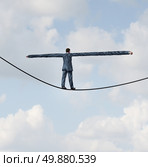 Adjust to risk with leadership solutions as a businessman with extremely stretched out arms for better balance walking on a tight rope to succeed at the road ahead as a business concept of adapting to challenges for strategy success. Стоковое фото, агентство Ingram Publishing / Фотобанк Лори