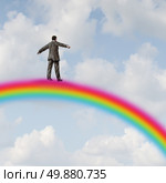 Success journey business concept with a businessman high up in the sky walking on a rainbow as a metaphor for financial opportunity direction and wealth strategy by following a winning plan leading to fortune. Стоковое фото, агентство Ingram Publishing / Фотобанк Лори