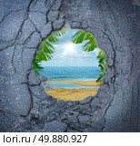 Escape city stress vacation dreaming as a dirty road pothole with the magical reflection of a tropical beach paradise scene as a metaphor for leisure holiday break from urban decay anxiety. Стоковое фото, агентство Ingram Publishing / Фотобанк Лори