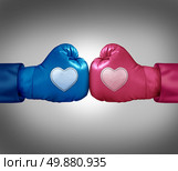 Fighting for love and relationship argument concept as blue and pink boxing gloves with heart shaped patches face off in a passionate couple dispute resulting in stress and possible separation or divorce. Стоковое фото, агентство Ingram Publishing / Фотобанк Лори