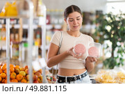 Girl looking at raw hamburger cutlet in store, choose meat ware. Стоковое фото, фотограф Яков Филимонов / Фотобанк Лори