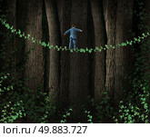 Green Technology Investing business concept as environmentally friendly companies supporting clean solutions for profit as a businessman walking through a dense forest on a tightrope made from a vine as a metaphor for reducing environmental imact and sustainability. Стоковое фото, агентство Ingram Publishing / Фотобанк Лори