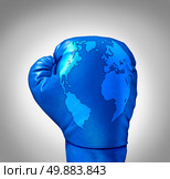 Global competition and competing globally as a business concept with a blue leather boxing glove with a map of the world incorporated in the texture as a symbol and metaphor for fighting international challenges. Стоковое фото, агентство Ingram Publishing / Фотобанк Лори