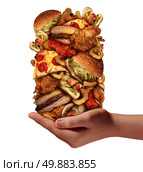 Over eating and compulsive indulgence of fast food concept as a hand holding up a huge stack of junk food as hamburgers hotdogs and french fries as an unhealthy diet nd bad nutrition symbol isolated on a white background. Стоковое фото, агентство Ingram Publishing / Фотобанк Лори