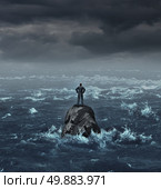 Stranded businessman lost at sea standing on an isolated rock as a business concept for financial despair or being lost and needing career or financial help to escape the crisis. Стоковое фото, агентство Ingram Publishing / Фотобанк Лори