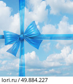 Dream gift from a fantasy wish list concept as an imaginary silk ribbon and bow on a sky background as a symbol of dreaming of holiday hopes for a merry Christmas and a joyful newyear. Стоковое фото, агентство Ingram Publishing / Фотобанк Лори