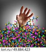 Holiday season stress concept as a human hand escaping from a chaotic tangled mess of three dimensional decoration lights as a symbol of seasonal distress and social anxiety. Стоковое фото, агентство Ingram Publishing / Фотобанк Лори