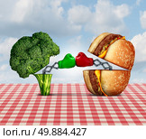 Diet battle and food fight nutrition concept as a fresh healthy broccoli fighting an unhealthy cheese burger with boxing gloves punching each other. Стоковое фото, агентство Ingram Publishing / Фотобанк Лори