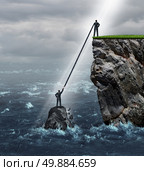 Embrace opportunity business concept as a person in a crisis stranded in the ocean being supported by an extended helping hand by another man on top of a high cliff on solid ground. Стоковое фото, агентство Ingram Publishing / Фотобанк Лори