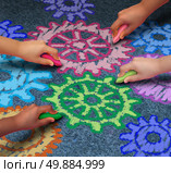 Education concept as a diverse community of children working together in friendship drawing connected gears and cog wheels with chalk as a symbol for the success of learning with a school program. Стоковое фото, агентство Ingram Publishing / Фотобанк Лори