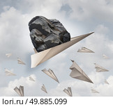 Power of motivation business success concept as a paper plane hauling a heavy rock with a group of failing origami airplanes as a metaphor for the force of determination. Стоковое фото, агентство Ingram Publishing / Фотобанк Лори