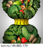 Healthy weight loss diet as a group of fresh fruits and vegetables with a fitness tape measure wrapped around a tight shrinking waistline shape as a metaphor for healthy lifestyle weightloss. Стоковое фото, агентство Ingram Publishing / Фотобанк Лори