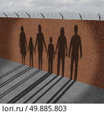 Immigration people on a border wall as a social issue about refugees or illegal immigrants crisis with the cast shadow of a group of migrating women men and children. Стоковое фото, агентство Ingram Publishing / Фотобанк Лори