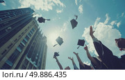 A group of graduates joyfully throwing their caps in the air to celebrate their academic achievement and mark the end of their educational journey. Стоковое AI-изображение, AI-художник Данила Большаков / Фотобанк Лори