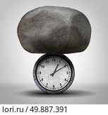 Time Pressure business concept as a huge rock pressing down on a clock as a stress metaphor for work schedule tension and overdue appointment burden symbol. Стоковое фото, агентство Ingram Publishing / Фотобанк Лори