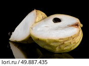 Custard apple, also known as Bullocks or Bulls Heart.On black with reflection. Стоковое фото, агентство Ingram Publishing / Фотобанк Лори