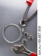 Tool and wires on metal finish background. Стоковое фото, агентство Ingram Publishing / Фотобанк Лори