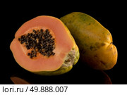 Fresh and tasty papaya on black background. Стоковое фото, агентство Ingram Publishing / Фотобанк Лори