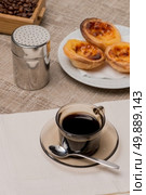 Pasteis de Nata or Portuguese Custard Tarts with black coffee on wooden table. Стоковое фото, агентство Ingram Publishing / Фотобанк Лори