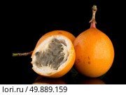 Passion fruit maracuja granadilla on black background. Стоковое фото, агентство Ingram Publishing / Фотобанк Лори