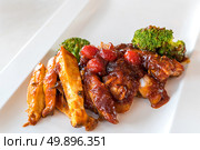 Pork Rib Grilled and Fried Potato Wedges on White Plate with Sauce and Veggies, Gourmet cuisine. Стоковое фото, агентство Ingram Publishing / Фотобанк Лори