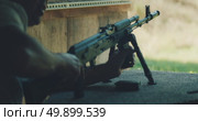 Man instructor prepares rifle on shooting bench during target practice. Стоковое видео, видеограф Igor Tichonow / Фотобанк Лори