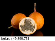 Passion fruit maracuja granadilla on black background. Стоковое фото, агентство Ingram Publishing / Фотобанк Лори