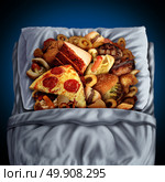 Night eating and late evening snacking concept as a food osession diet disorder with unhealthy junk food and snacks sleeping in bed as a midnight snack metaphor in a 3D illustration style. Стоковое фото, агентство Ingram Publishing / Фотобанк Лори
