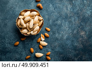 Almond nuts on dark background directly above copy space flat lay. Стоковое фото, агентство Ingram Publishing / Фотобанк Лори