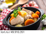 Meat stewed with carrots and potatoes in sauce on wooden rustic background. Стоковое фото, агентство Ingram Publishing / Фотобанк Лори