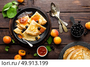 Pancakes with fresh blackcurrant and apricot jam. Стоковое фото, агентство Ingram Publishing / Фотобанк Лори