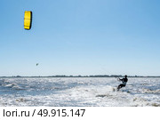 Kiteboarder enjoy surfing on a sunny day. Стоковое фото, агентство Ingram Publishing / Фотобанк Лори