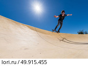 Skateboarder practice on a pump track park on a sunny summer day. Стоковое фото, агентство Ingram Publishing / Фотобанк Лори