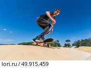 Skateboarder practice on a pump track park on a sunny summer day. Стоковое фото, агентство Ingram Publishing / Фотобанк Лори