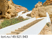 Stairs to a pool of natural sea water between sandstone cliffs at Algar Seco. Carvoeiro Algarve Portugal. Стоковое фото, агентство Ingram Publishing / Фотобанк Лори