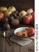 Persimmon fruit on rustic table in vintage style. Стоковое фото, агентство Ingram Publishing / Фотобанк Лори