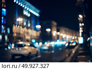Blurred city at night. Bokeh. Beautiful abstract background with defocused buildings, cars, city lights, people. Colorful bokeh background with urban night scene. Design. Concept backdrop. Vintage  . Blurred city at night. Bokeh. Стоковое фото, агентство Ingram Publishing / Фотобанк Лори