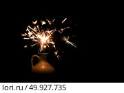Christmas holding bengal burning sparkler light. Стоковое фото, агентство Ingram Publishing / Фотобанк Лори