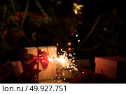 Christmas holding bengal burning sparkler light. Стоковое фото, агентство Ingram Publishing / Фотобанк Лори