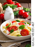 Pasta salad with fresh red cherry tomato and feta cheese. Italian cuisine. Стоковое фото, агентство Ingram Publishing / Фотобанк Лори