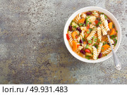 Minestrone soup. Vegetable soup with fresh tomato, celery, carrot, zucchini, onion, pepper, beans and pasta. Dish of italian cuisine. Стоковое фото, агентство Ingram Publishing / Фотобанк Лори