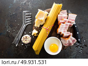 Ingredients for cooking Carbonara pasta, spaghetti with pancetta, egg and hard parmesan cheese. Traditional italian cuisine. Pasta alla carbonara. Стоковое фото, агентство Ingram Publishing / Фотобанк Лори