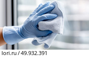 Cleaning glass surfaces with microfiber cloth in a bright indoor space. Стоковое AI-изображение, AI-художник Katsiaryna Repich / Фотобанк Лори