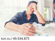 Bad investment or economic crisis concept. Businessman is disappointed from losing in business situation. Стоковое фото, агентство Ingram Publishing / Фотобанк Лори
