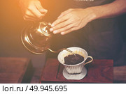 Drip brewing, filtered coffee, or pour-over is a method which involves pouring water over roasted, ground coffee beans contained in a filter. Стоковое фото, агентство Ingram Publishing / Фотобанк Лори