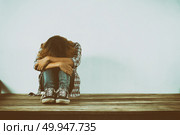 Sad woman hug her knee,nobody . Стоковое фото, агентство Ingram Publishing / Фотобанк Лори