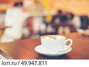 Cup of cappuccino at coffee shop background. . Стоковое фото, агентство Ingram Publishing / Фотобанк Лори