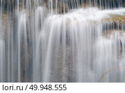 Erawan Waterfall, beautiful waterfall with sunlight rays in deep forest, Erawan National Park in Kanchanaburi, Thailand. Стоковое фото, агентство Ingram Publishing / Фотобанк Лори