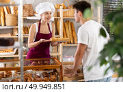 Young woman seller gives bocadillo to man buyer. Стоковое фото, фотограф Яков Филимонов / Фотобанк Лори