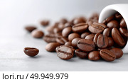 Freshly roasted coffee beans spilled from a white cup on a kitchen counter. Стоковое AI-изображение, AI-художник Katsiaryna Repich / Фотобанк Лори